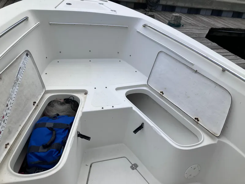 Slide: The Image of 2005 Sailfish 266 CC boat interior with open storage compartments. - 31
