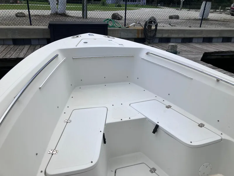 Slide: The Image of 2005 Sailfish 266 CC boat interior with white seating and storage compartments. - 33