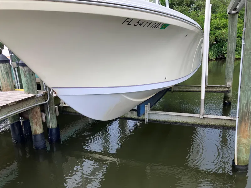 Slide: The Image of 2005 Sailfish 266 CC boat on lift, docked in marina. - 6