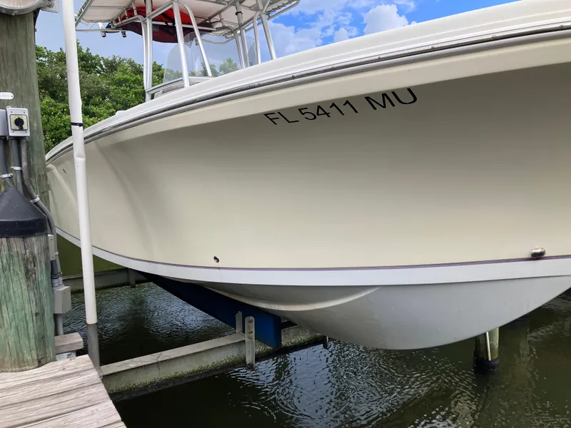 Slide: The Image of 2005 Sailfish 266 CC boat docked, side view with registration number FL 5411 MU. - 7