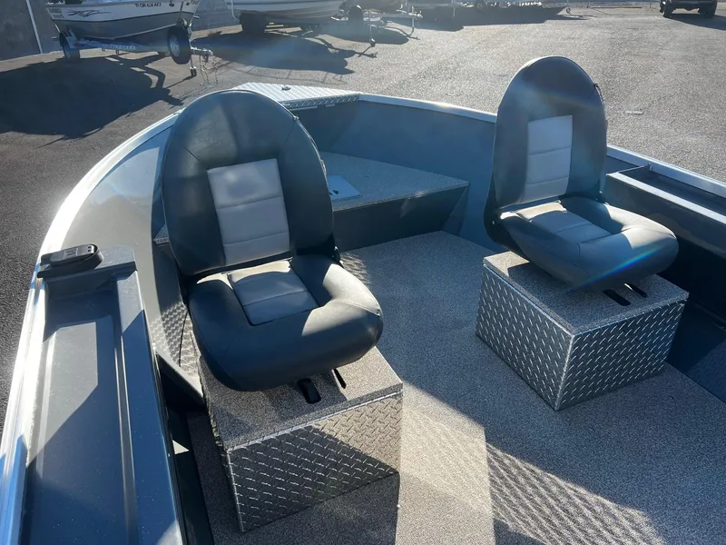 Slide: The Image of 2024 Fish Rite Angler 18 boat interior with two cushioned seats on metal bases. - 10