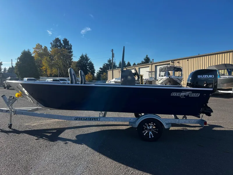 Slide: The Image of 2024 Fish Rite Angler 18 boat on trailer, parked outdoors under clear sky. - 4