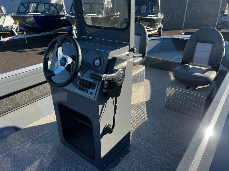 Slide: The Image of 2024 Fish Rite Angler 18 boat interior with steering console and seating. - 8