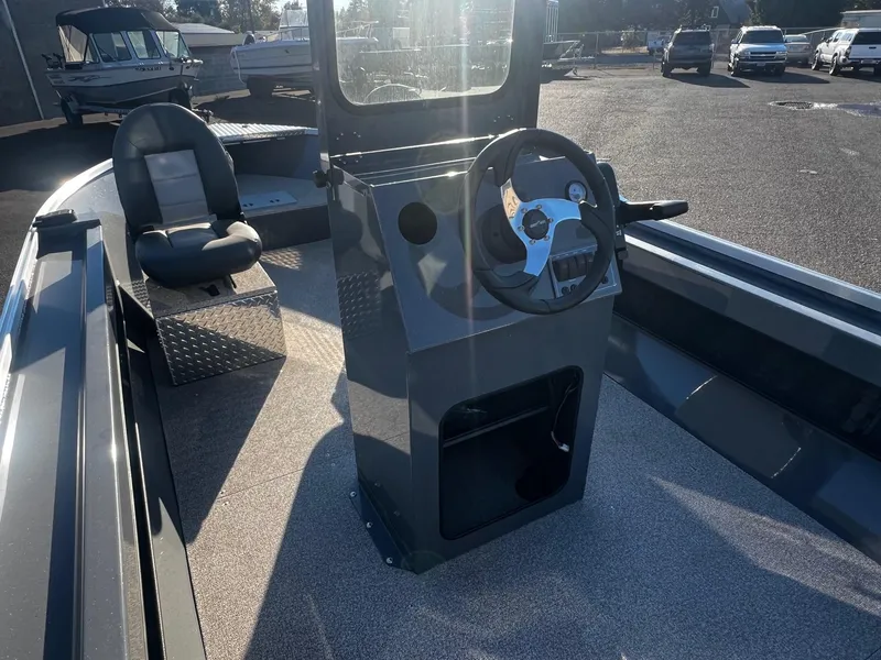 Slide: The Image of 2024 Fish Rite Angler 18 boat interior with steering console and seating. - 9
