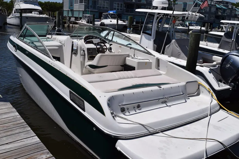 Slide: The Image of 2001 Crownline 288 BR boat docked at marina, featuring spacious seating and sleek design. - 1