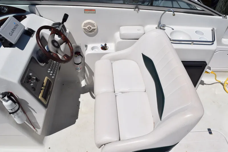 Slide: The Image of 2001 Crownline 288 BR boat cockpit with steering wheel and seating area. - 10