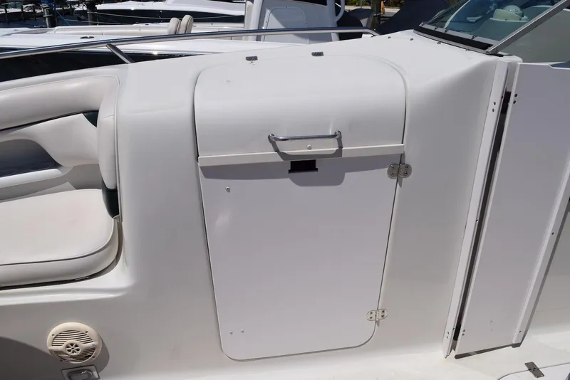 Slide: The Image of 2001 Crownline 288 BR boat interior with white seating and storage compartment. - 16