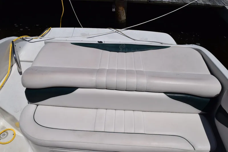 Slide: The Image of Crownline 288 BR 2001 boat seating with white and dark green upholstery. - 19
