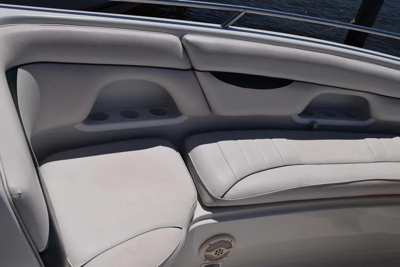 Slide: The Image of Luxurious seating on a 2001 Crownline 288 BR boat, featuring white upholstery and cup holders. - 20