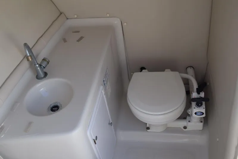 Slide: The Image of 2001 Crownline 288 BR boat bathroom with sink and marine toilet. - 21
