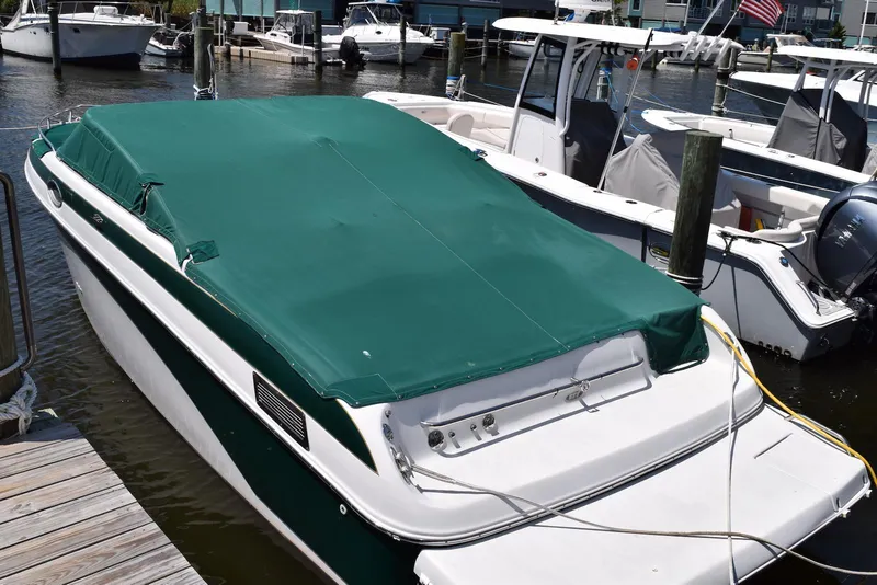 Slide: The Image of 2001 Crownline 288 BR boat with green cover docked at marina. - 23