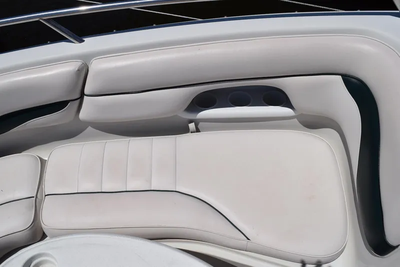 Slide: The Image of Crownline 288 BR 2001 boat interior with white cushioned seating and cup holders. - 7