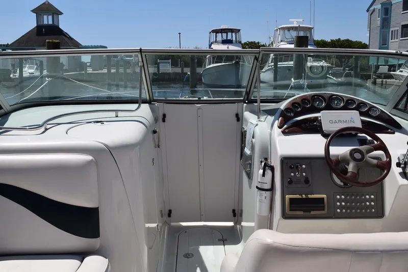 Slide: The Image of 2001 Crownline 288 BR boat cockpit with Garmin navigation, docked at marina. - 8