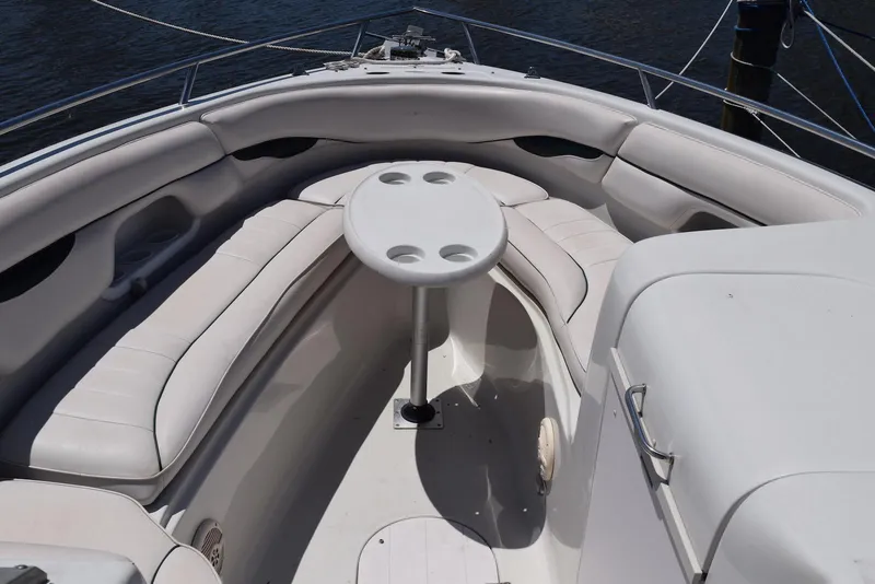 Slide: The Image of 2001 Crownline 288 BR boat interior with white seating and round table. - 9