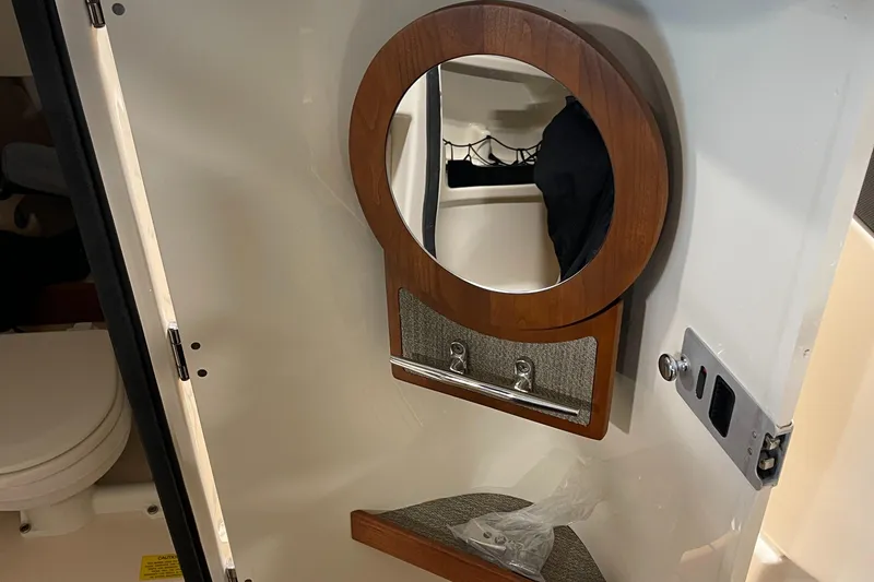 Slide: The Image of 2016 Grady-White 275 Freedom boat interior with mirror and storage. - 13