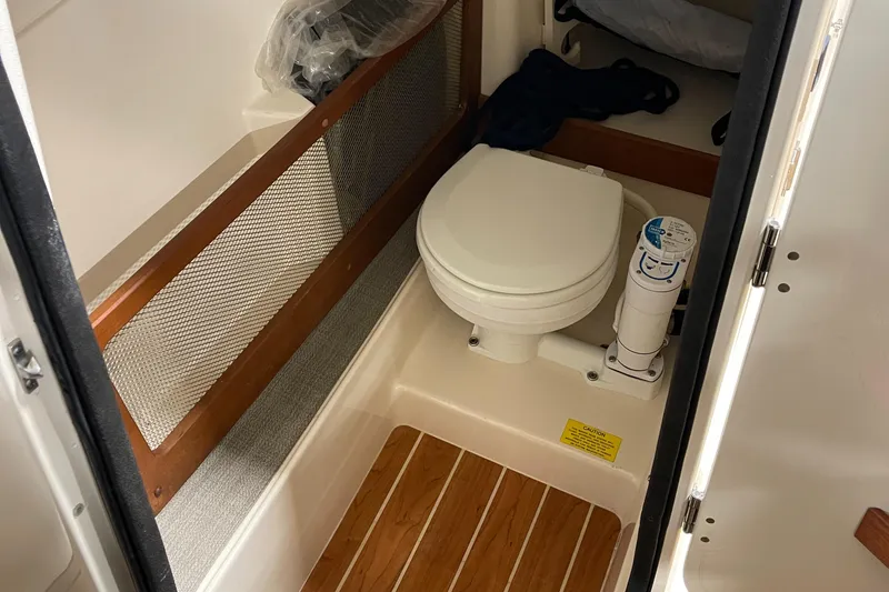 Slide: The Image of 2016 Grady-White 275 Freedom boat interior with compact marine toilet. - 14