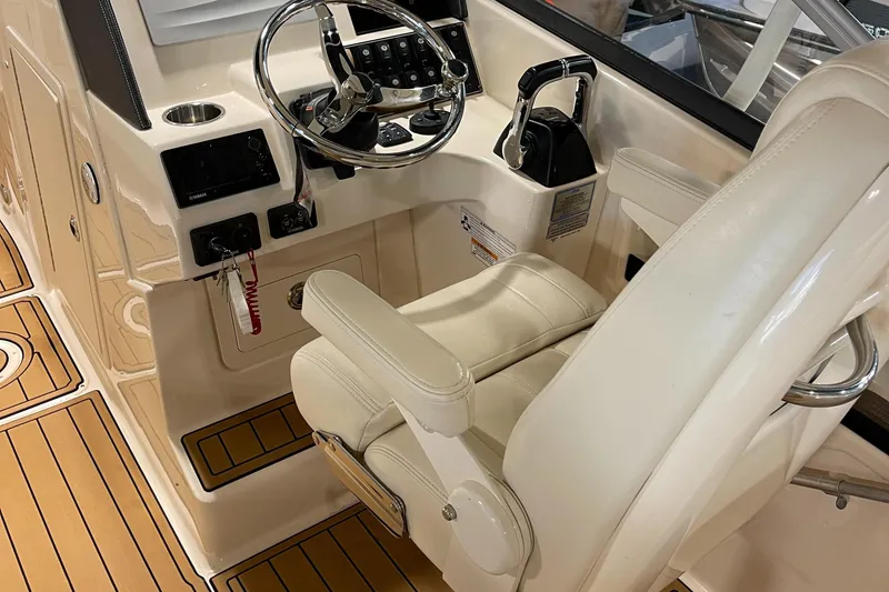 Slide: The Image of 2016 Grady-White 275 Freedom boat cockpit with steering wheel and control panel. - 15