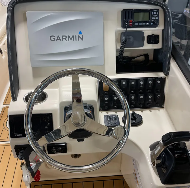 Slide: The Image of Grady-White 275 Freedom 2016 boat dashboard with Garmin navigation system and controls. - 16