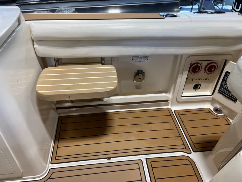 Slide: The Image of 2016 Grady-White 275 Freedom boat interior with teak flooring and foldable seat. - 17