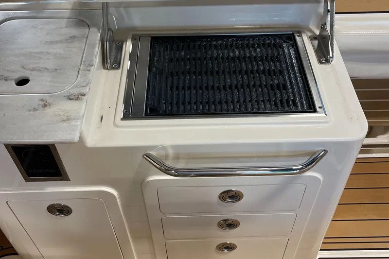 Slide: The Image of Grady-White 275 Freedom 2016 boat grill and sink area with storage drawers. - 20