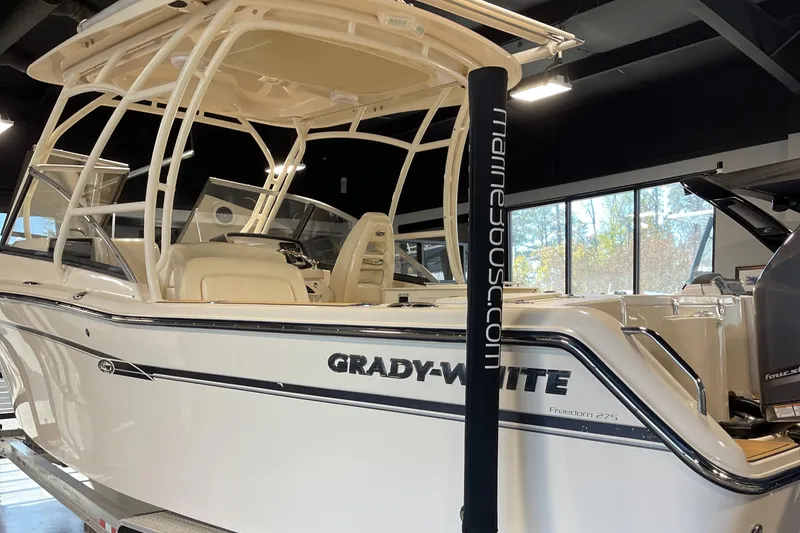 Slide: The Image of 2016 Grady-White 275 Freedom boat displayed indoors, showcasing sleek design and modern features. - 3