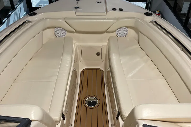 Slide: The Image of 2016 Grady-White 275 Freedom boat interior with beige seating and wood flooring. - 7