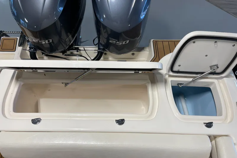Slide: The Image of 2016 Grady-White 275 Freedom boat with open storage compartments and dual engines. - 9