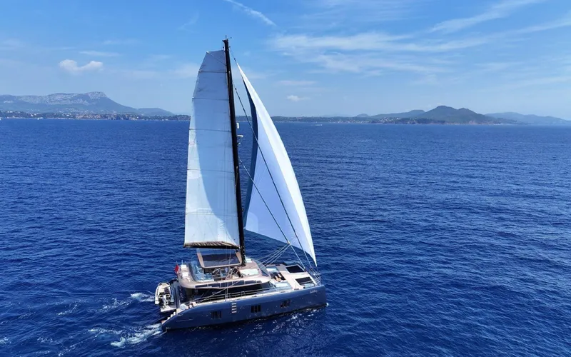 The Image of 2024 Sunreef 60 Sail catamaran cruising on open blue sea. - 0