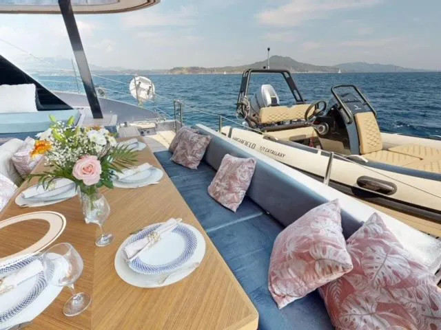 Slide: The Image of Luxurious 2024 Sunreef 60 Sail yacht with elegant dining setup and scenic ocean view. - 1