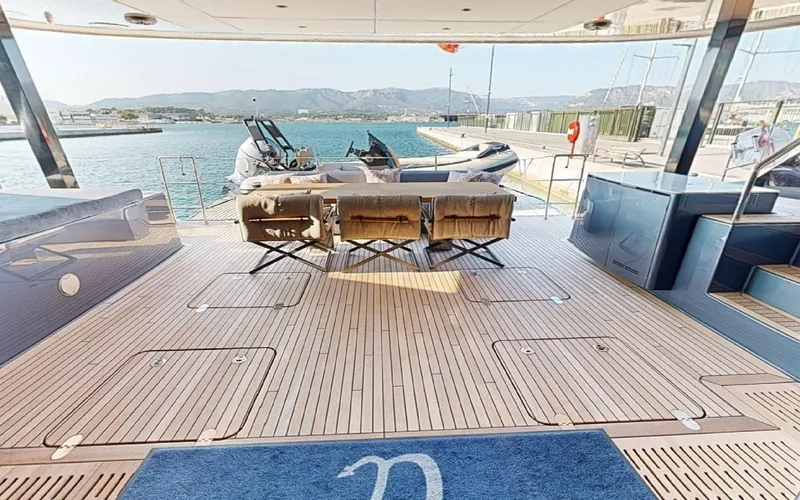Slide: The Image of Luxurious Sunreef 60 Sail yacht deck with seating, overlooking serene waters, 2024 model. - 14
