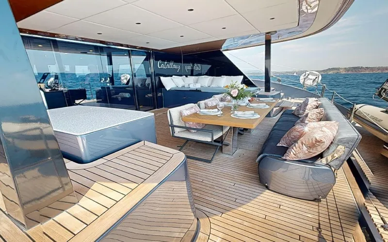 Slide: The Image of Luxurious deck of 2024 Sunreef 60 Sail yacht with elegant seating and dining area. - 15