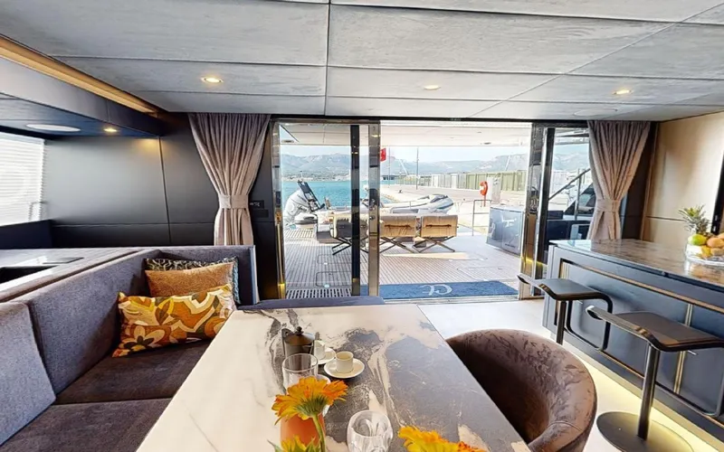 Slide: The Image of Luxurious interior of 2024 Sunreef 60 Sail yacht with elegant dining area and ocean view. - 19