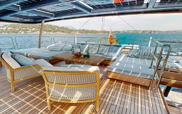 Slide: The Image of Luxurious Sunreef 60 Sail 2024 yacht deck with elegant seating and ocean view. - 2