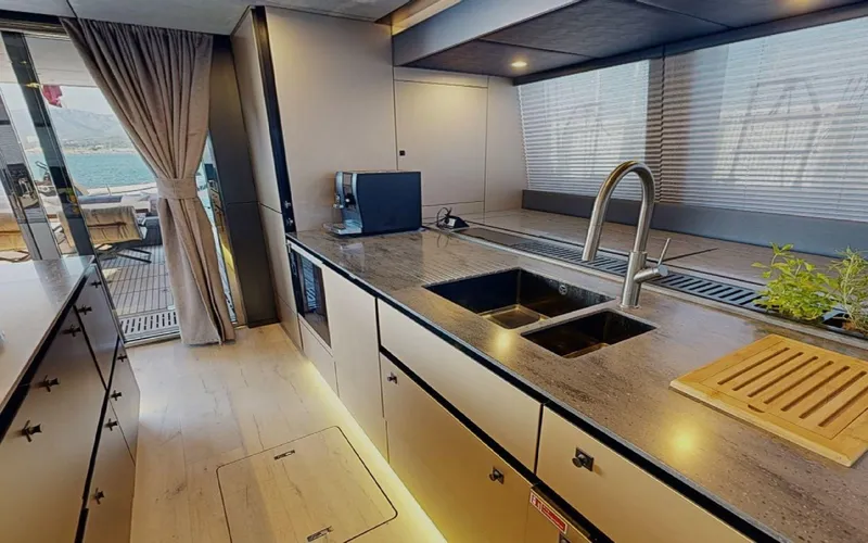 Slide: The Image of Luxurious kitchen interior of 2024 Sunreef 60 Sail yacht with modern fixtures and ample counter space. - 3
