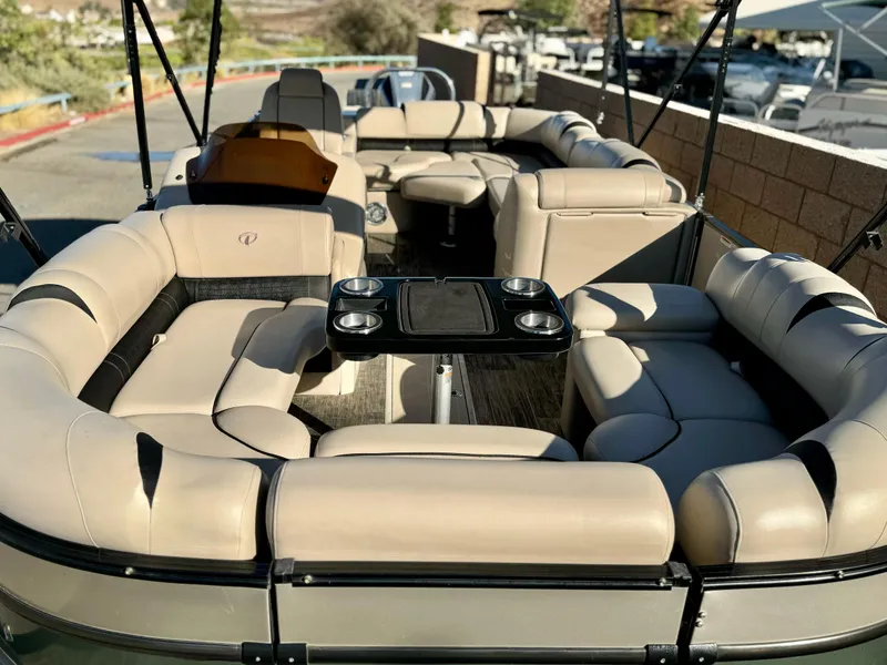 Slide: The Image of 2022 Tahoe Pontoon Cascade Platinum Rear J Lounger with luxurious seating and table. - 11