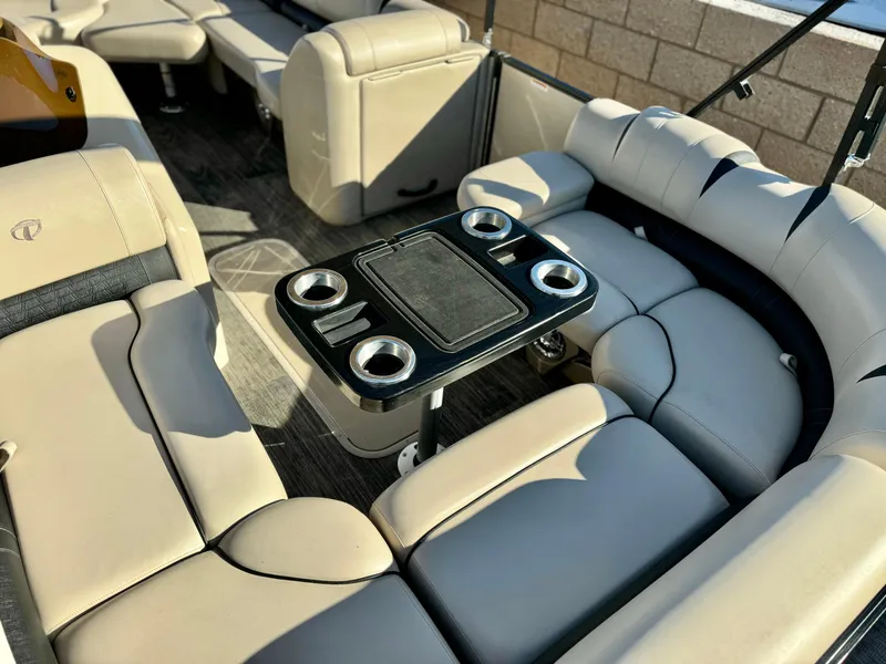 Slide: The Image of 2022 Tahoe Pontoon Cascade Platinum Rear J Lounger with beige seating and cupholders. - 12