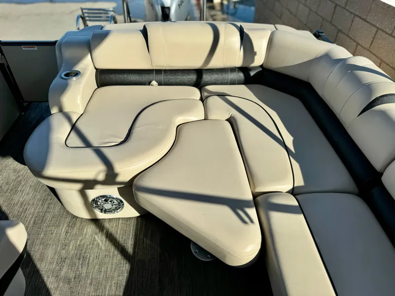 Slide: The Image of 2022 Tahoe Pontoon Cascade Platinum Rear J Lounger with beige seating and cup holder. - 18