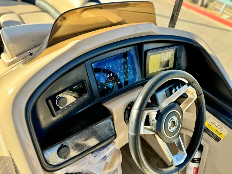 Slide: The Image of 2022 Tahoe Pontoon Cascade Platinum dashboard with steering wheel and digital displays. - 21