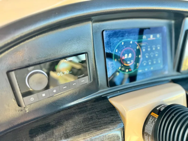 Slide: The Image of Dashboard of 2022 Tahoe Pontoon Cascade Platinum with digital displays and controls. - 22