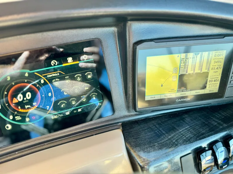 Slide: The Image of Dashboard of 2022 Tahoe Pontoon Cascade Platinum with digital displays and controls. - 23