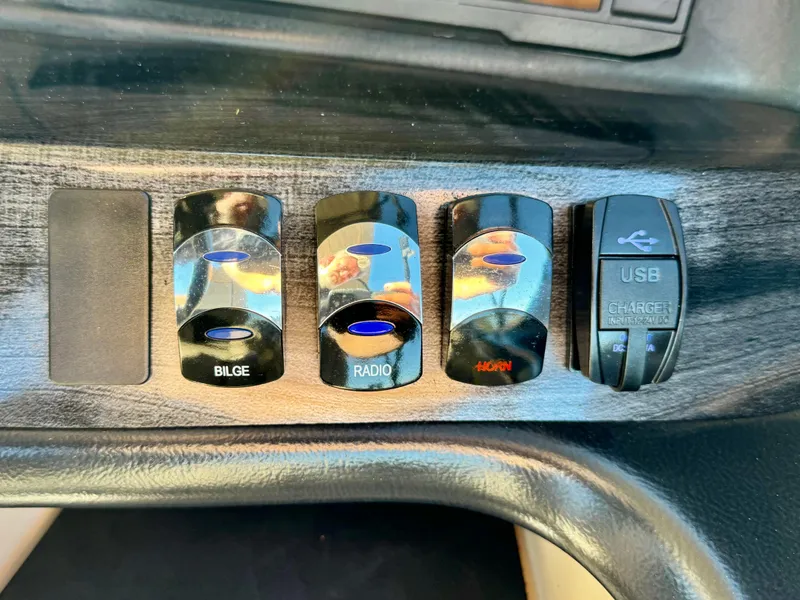 Slide: The Image of Control panel of 2022 Tahoe Pontoon Cascade Platinum with bilge, radio, and USB charger switches. - 24