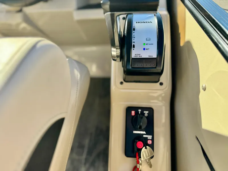 Slide: The Image of 2022 Tahoe Pontoon Cascade Platinum control panel with Honda throttle and ignition keys. - 25