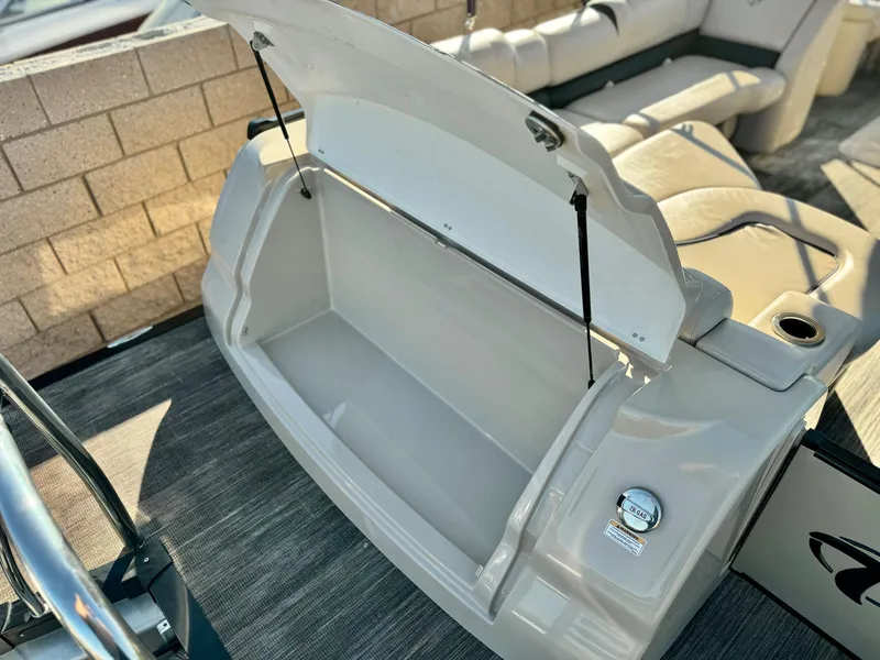 Slide: The Image of 2022 Tahoe Pontoon Cascade Platinum Rear J Lounger storage compartment open. - 28