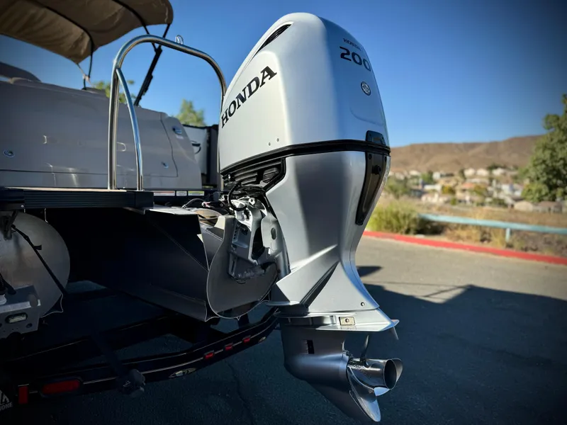 Slide: The Image of 2022 Tahoe Pontoon Cascade Platinum with Honda 200 outboard motor, parked outdoors. - 5