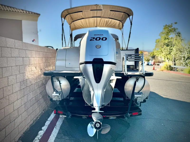 Slide: The Image of 2022 Tahoe Pontoon Cascade Platinum with Honda 200 engine, parked on street. - 6