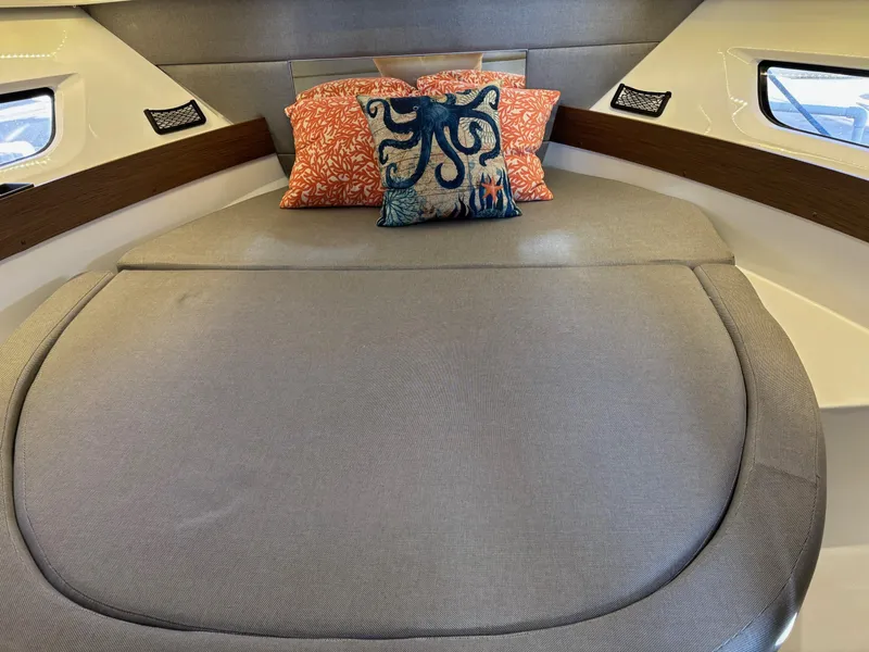 Slide: The Image of Cozy cabin interior of 2018 Jeanneau NC 895 with decorative pillows. - 17