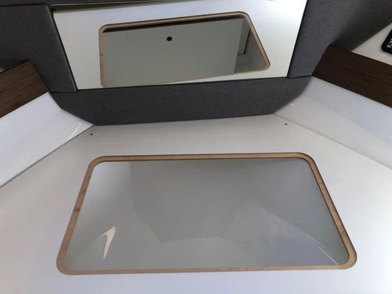 Slide: The Image of Interior view of 2018 Jeanneau NC 895 boat cabin with mirror and window. - 21