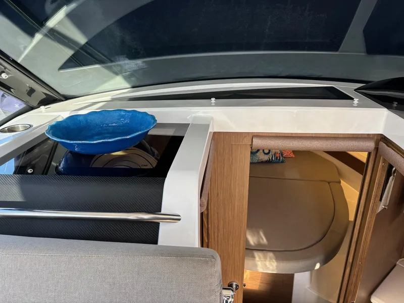 Slide: The Image of Interior of 2018 Jeanneau NC 895 boat with modern design and blue dish. - 22