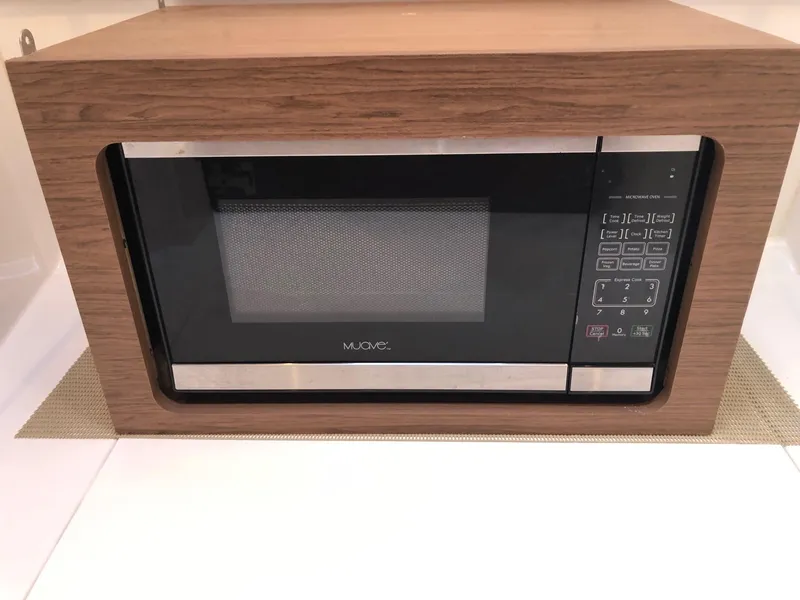 Slide: The Image of Built-in microwave in Jeanneau NC 895 boat, 2018 model, with wood paneling. - 26