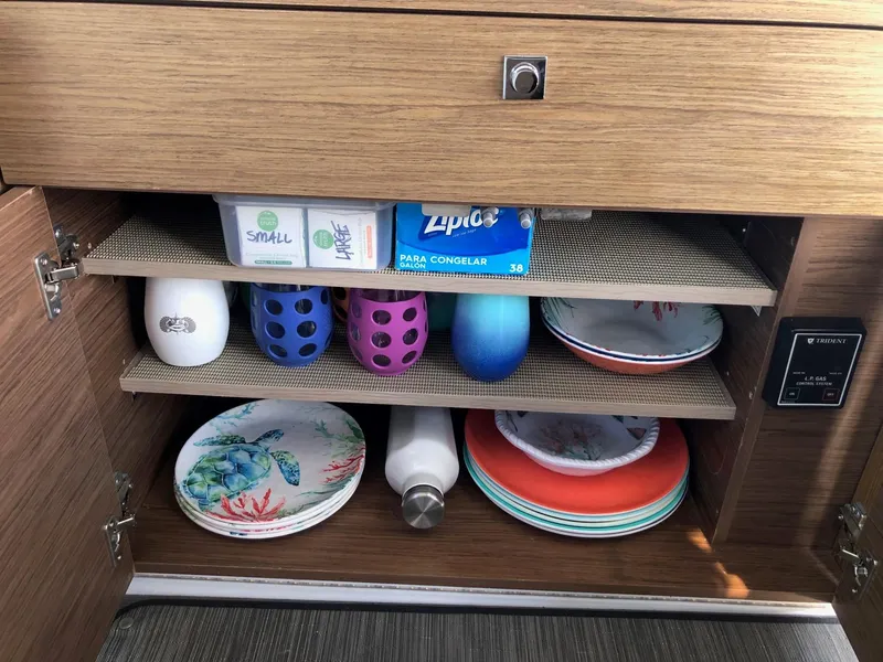 Slide: The Image of Cabinet storage in 2018 Jeanneau NC 895 boat with dishes and cups. - 27
